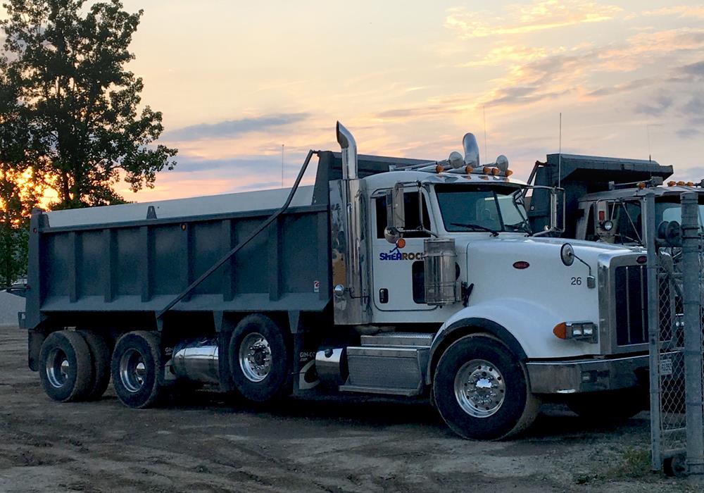 A photo of the Peterbilt dump truck that SheaRock Construction Group leased with CWB National Leasing